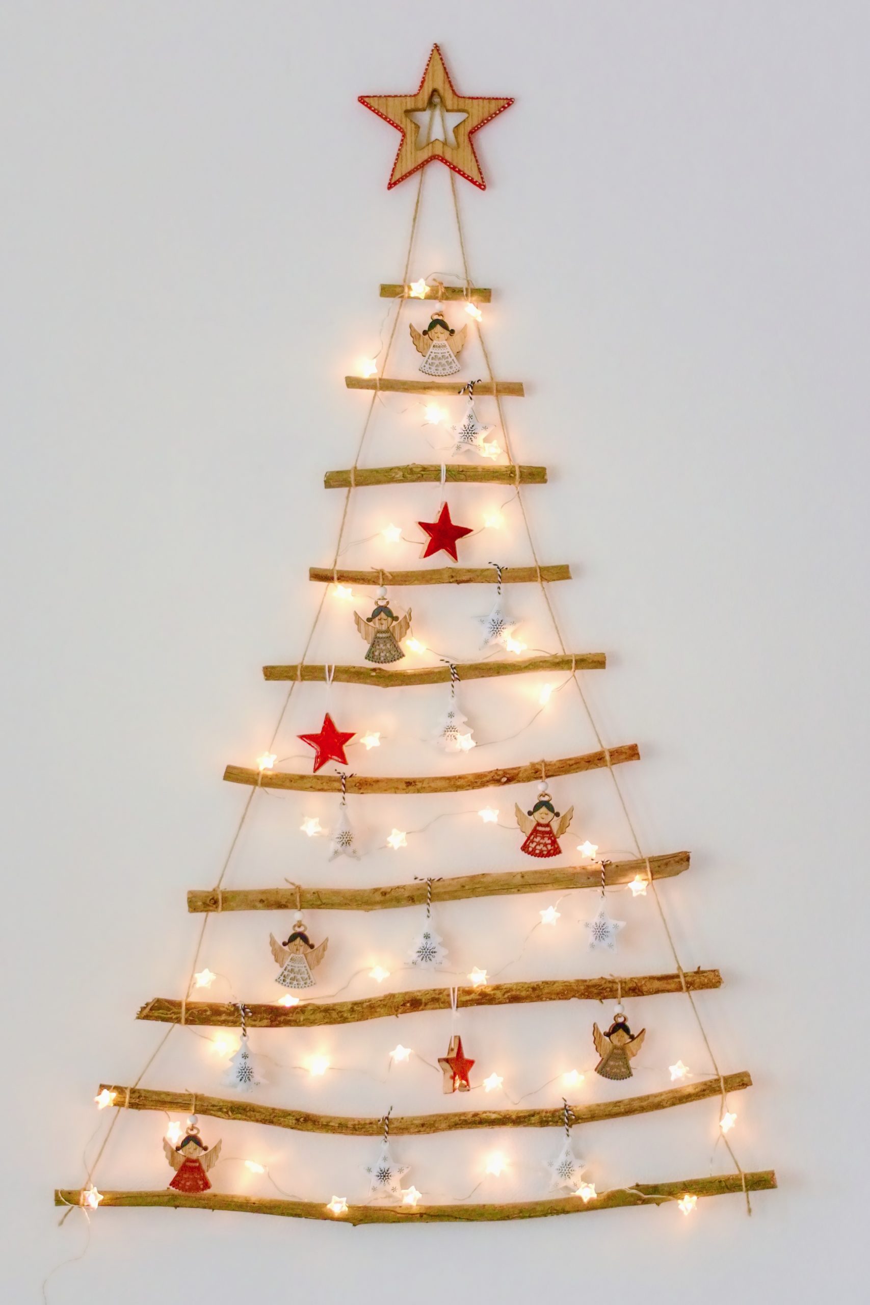 Christmas creative decoration - homemade wooden hanging christmas tree on the wall