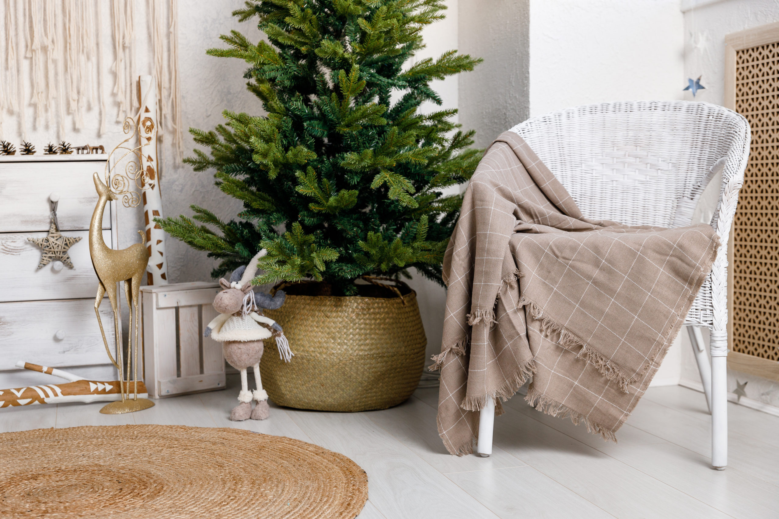 Modern interior design room with Christmas and New Year decorations, toys, gifts, fir tree, hanging swing. Winter holidays composition.